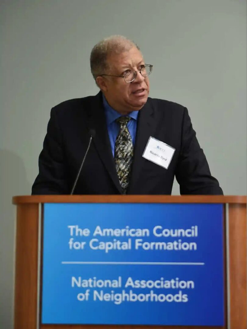 A man standing at the podium of an event.