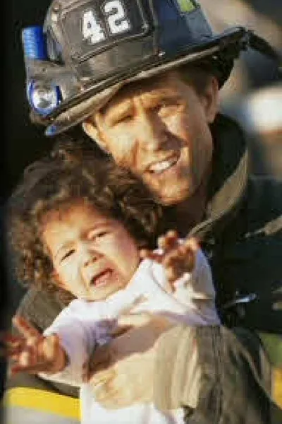 A man holding a child in his arms.