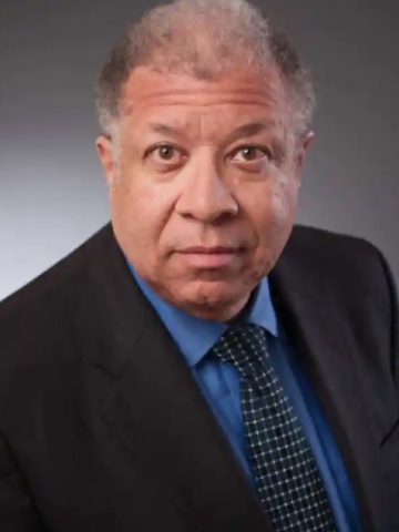 A man in a suit and tie posing for the camera.