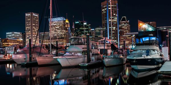 A group of boats in the water at night.