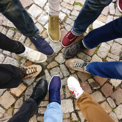 A group of people standing in the middle of a circle.