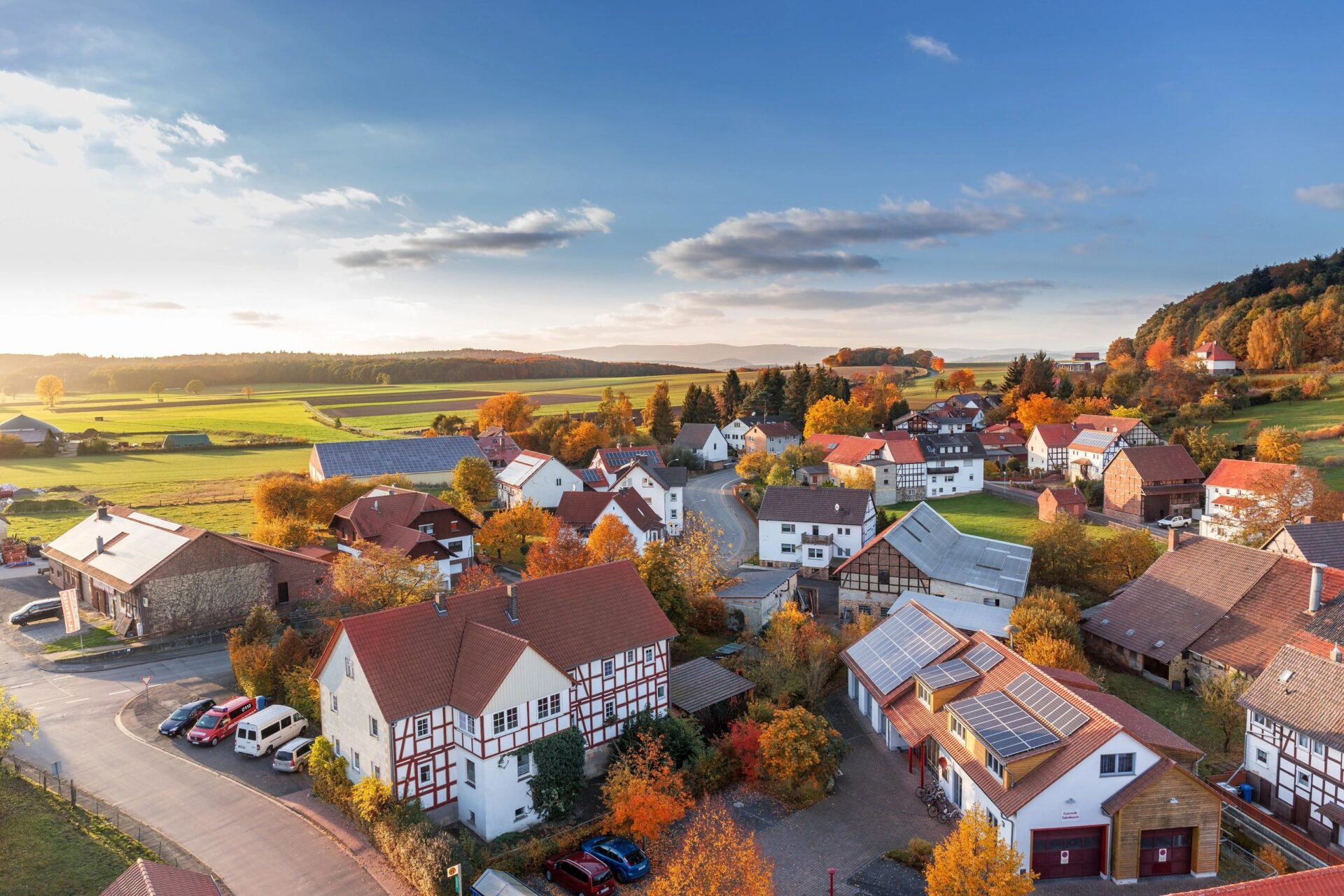 A view of houses from above with the sun setting.